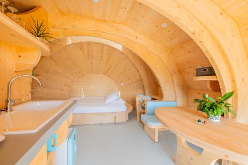 a room with a bed and a sink in a room at Les chaumières de Brameix in Neuvic