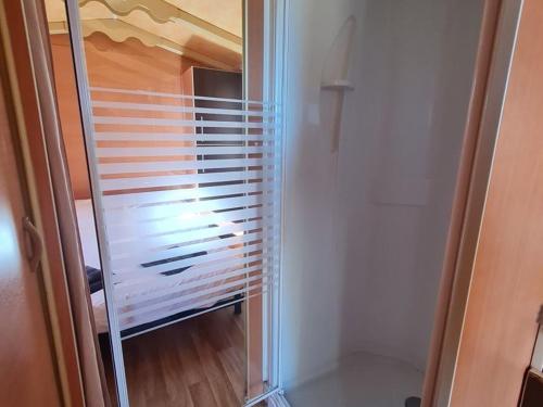 a glass door of a closet with blinds at stop roulotte in Burthecourt-aux-Chênes