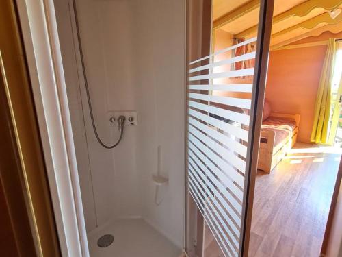 a bathroom with a shower and a bedroom at stop roulotte in Burthecourt-aux-Chênes