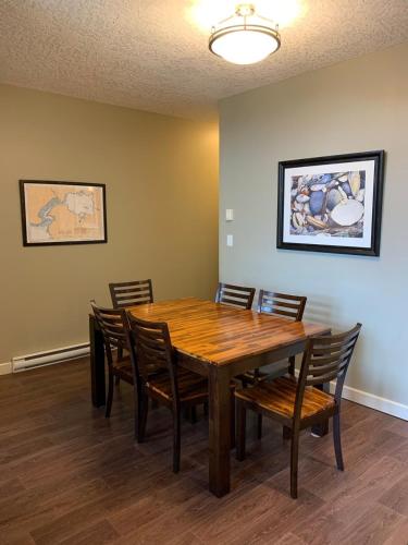 a dining room with a wooden table and chairs at Race Rocks Townhouse - Sooke in Sooke