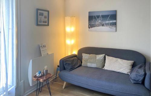 un salon avec un canapé bleu et une table dans l'établissement 1 Bedroom Nice Apartment In Pornichet, à Pornichet