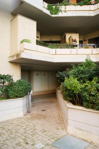 a building with plants on the side of it at Catia Sweet Holiday 2 in Fiumicino
