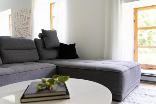 a living room with a couch and a table at Maison Rasco by Luxury In Transit in Montréal