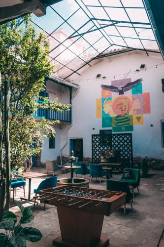 a patio with a table and chairs and a boardgame at Way Kap Hostel Cusco in Cusco