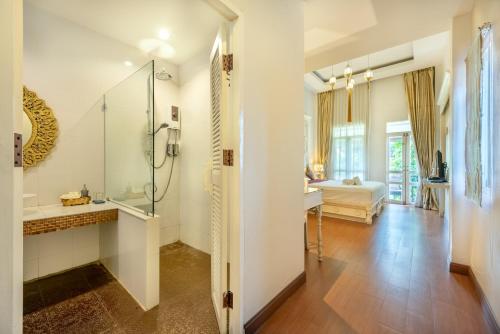 a bathroom with a shower and a sink at SHIN Hotel Chiangmai Gate in Chiang Mai