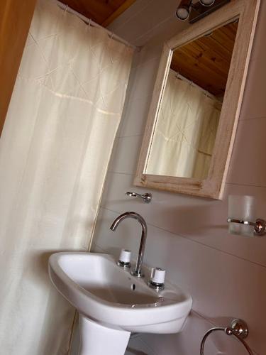 a bathroom with a sink and a mirror at Cabañas del Viñedo in La Paz