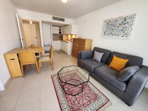 a living room with a couch and a table at Appartement Nice Carré d Or in Nice