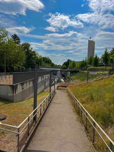a walkway next to a field with a bridge at Apartment Stuttgart Flughafen Messe in Stuttgart