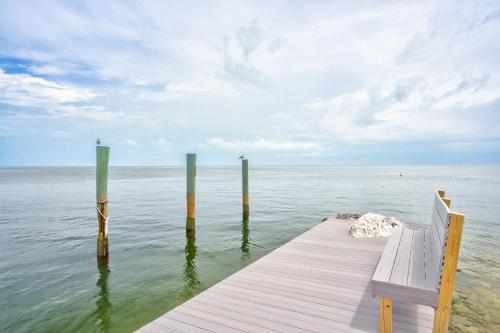 a bench sitting on a dock in the water at Aqua Lodges at 47th Street in Marathon