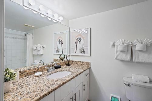 a bathroom with a sink and a toilet and a mirror at Sunrise Resort 210 in St Pete Beach