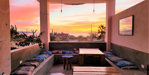 a balcony with a table and a view of the ocean at La Ventana Hostel in La Ventana