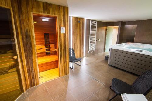 a kitchen with a tub and a sink in a room at Apartments Club Telgárt in Telgárt