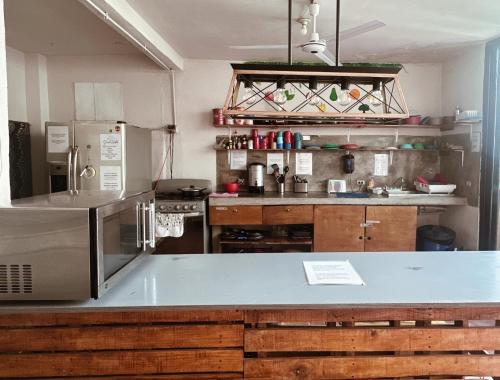 a kitchen with a counter top and a refrigerator at Sunset Hostel - Centro - in La Paz