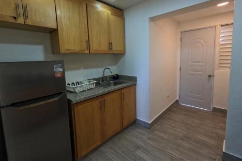 an empty kitchen with a sink and a refrigerator at La Yarolina in Punta Cana