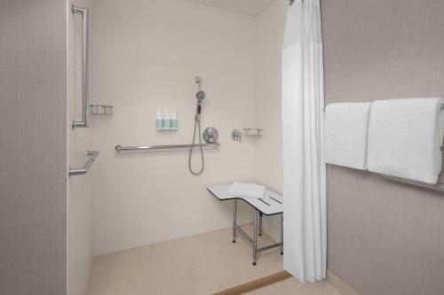 a white bathroom with a shower and a sink at Residence Inn by Marriott Santa Clarita Valencia in Santa Clarita