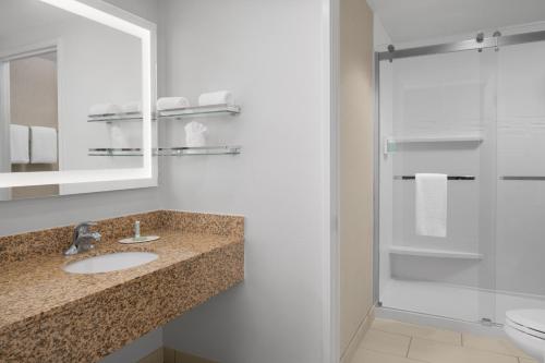 a bathroom with a sink and a shower with a mirror at Residence Inn by Marriott Santa Clarita Valencia in Santa Clarita