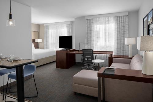 a hotel room with a bed and a living room at Residence Inn by Marriott Santa Clarita Valencia in Santa Clarita