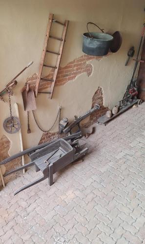 a room with a gun on the wall and a ladder at dormire e mangiare da Geppe in Montemagno