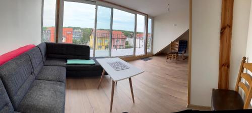 a living room with a couch and a table at Apartamenty Bezrzecze in Szczecin