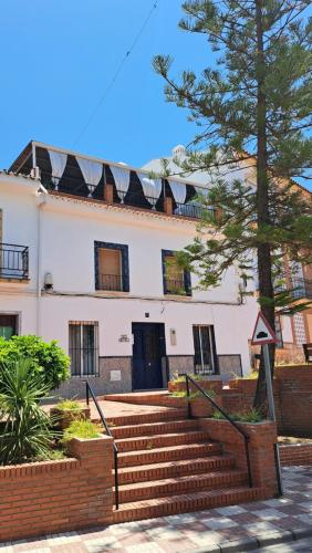 a building with stairs in front of a building at Casa Amapola in Alhaurín el Grande