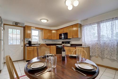 a kitchen with a wooden table and a dining room at Getaway Near ORD With Great Local Amenities in Des Plaines