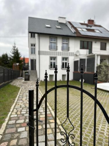 a black iron fence in front of a house at Apartamenty Bezrzecze in Szczecin