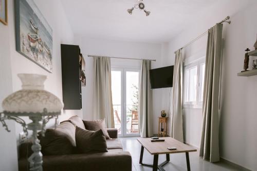 a living room with a couch and a table at Kampos Bliss Apartments in Votsalákia