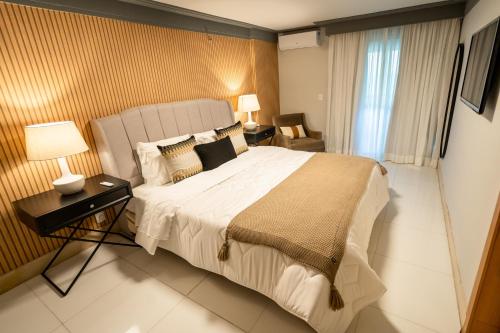 a bedroom with a large bed in a room at Royal Macaé Palace Hotel in Macaé