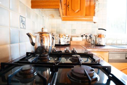 a kitchen stove top with a tea kettle on it at The Scotch Rock in Castlewellan