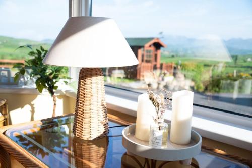 a lamp sitting on a glass table next to a window at The Scotch Rock in Castlewellan