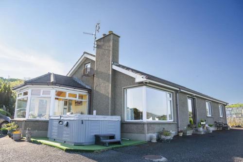 a house with a large window on the side of it at The Scotch Rock in Castlewellan