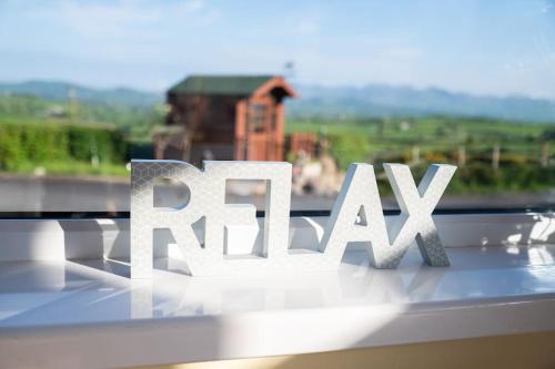 a white sign that reads railay in front of a window at The Scotch Rock in Castlewellan