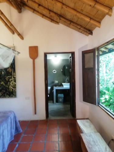 a room with a door leading to a bathroom at Casa El Cedro in Charalá