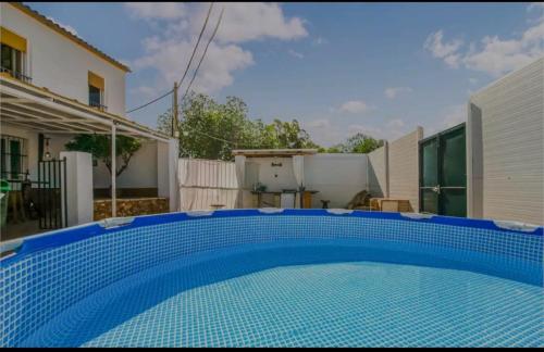 a blue swimming pool in the backyard of a house at La Parrita in Guadalcanal