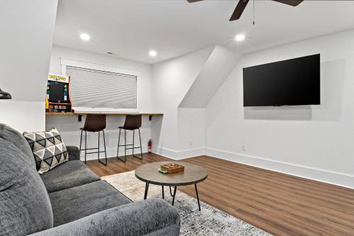 a living room with a couch and a flat screen tv at Higher Ground at Lake James in Nebo