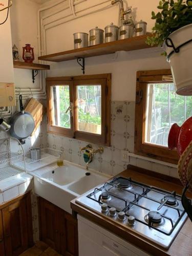a kitchen with a stove top and a sink at La Torre del Vicario in Palazzuolo sul Senio
