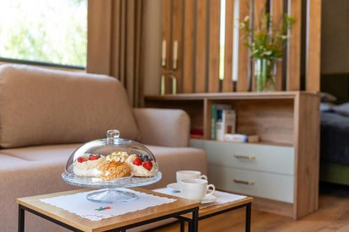 a living room with a tray of food on a table at Zielona Żaba in Derc