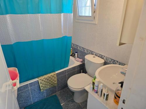 a bathroom with a toilet and a sink at Villa Maya in Paralimni