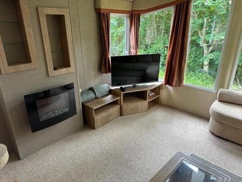 Wild Atlantic Way Stay Carrigart في دونيجال: غرفة معيشة مع تلفزيون ومدفأة