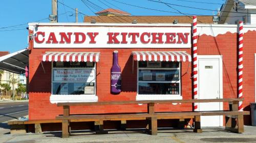 a candy kitchen with a bottle and a bench at Beachway Beach Stay in Seminole