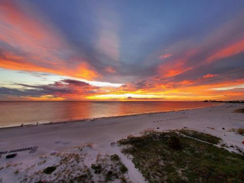 a view of a beach with a sunset at Beachway Beach Stay in Seminole