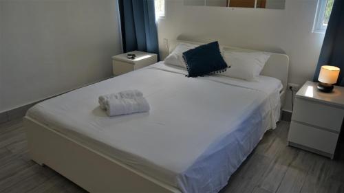 a bedroom with a large white bed with two night stands at La Yarolina in Punta Cana