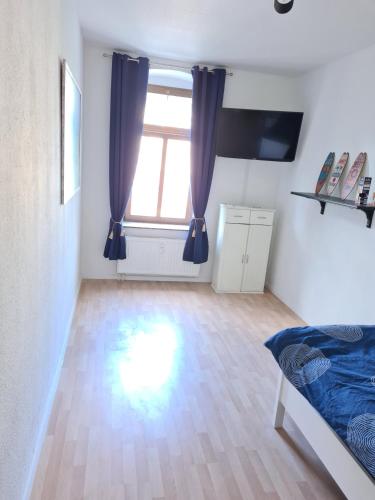 a bedroom with a bed and a large window at Chemnitz - Home Sweet Home in Chemnitz