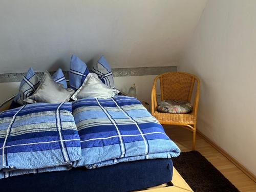 a bed with blue and white blankets and pillows at Ferienwohnung Winzenburg in der Nähe vom Steinhuder Meer und Dinopark Münchehagen in Rehburg-Loccum