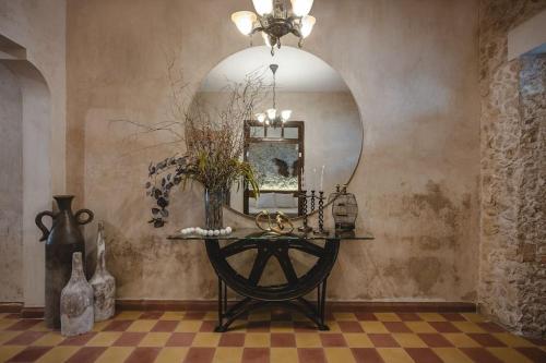 a room with a table with a mirror on a wall at Itinerante/Casa del Mago. Mérida in Mérida