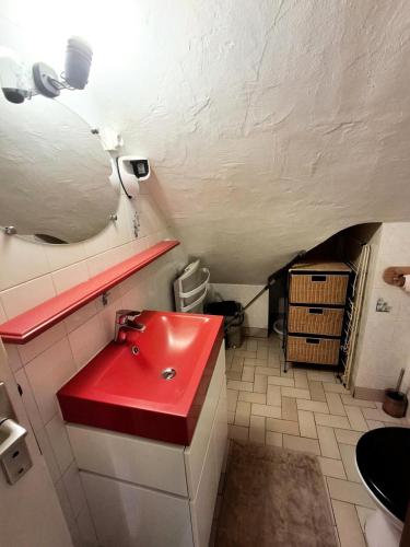 La salle de bains est pourvue d'un lavabo rouge. dans l'établissement Résidence Sport Alp - Studio cabine 4 personnes 2 exposé Est MAE-8844, à Valloire