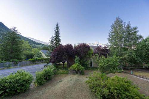 a house on the side of a road with trees at Rive Tranquille - Plan d'eau - Accès au lac in Jausiers