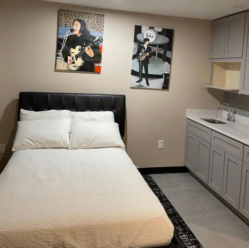 a large bed in a room with a kitchen at Broadway and Main Hotel in Everett