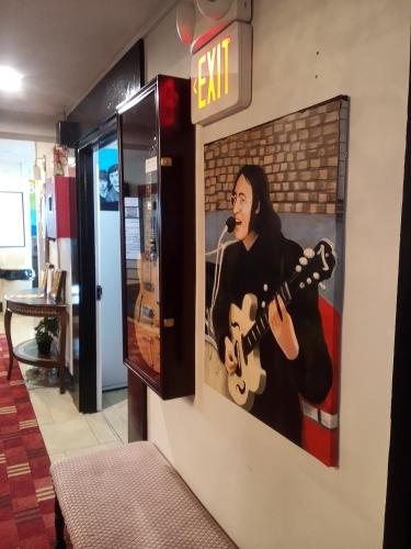 a poster of a man playing a guitar on a wall at Broadway and Main Hotel in Everett
