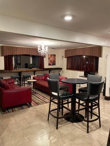a living room with a table and a red couch at Broadway and Main Hotel in Everett